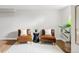 Bright living room with hardwood floors, stylish chairs, a sleek accent table, and decorative plants at 2970 Leyden St, Denver, CO 80207