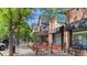 Scoops Ice Cream shop exterior view with outdoor seating, signage, and tree-lined sidewalk, inviting atmosphere at 2970 Leyden St, Denver, CO 80207
