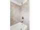 Shower with tile surround, white bathtub, and a chrome showerhead at 2970 Leyden St, Denver, CO 80207