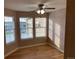 Bedroom featuring three windows, hardwood floors, a ceiling fan, and neutral walls at 15346 Heritage Cir, Thornton, CO 80602