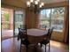 Traditional dining room featuring a chandelier and a table covered with a red patterned tablecloth at 15346 Heritage Cir, Thornton, CO 80602