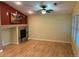 Living room with hardwood floors, a stone fireplace, and a ceiling fan for added comfort at 15346 Heritage Cir, Thornton, CO 80602