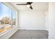 Bright bedroom features plush gray carpeting, neutral paint, ceiling fan, and a large window at 5379 W 14Th Ave, Lakewood, CO 80214