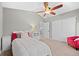 Bright bedroom with a ceiling fan, closet, and a chair adding a pop of color at 5410 S Vivian St, Littleton, CO 80127