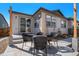 Backyard featuring a patio with outdoor seating, sliding glass doors, and exterior of the home at 3522 N Buchanan Way, Aurora, CO 80019