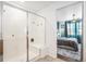 Bright bathroom with a glass-enclosed shower and bench, with view to main bedroom at 3522 N Buchanan Way, Aurora, CO 80019