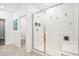Bright bathroom featuring a glass-enclosed shower with built-in seat and tiled walls at 3522 N Buchanan Way, Aurora, CO 80019