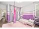 A bedroom with a playful purple and white striped wall, with curtains and a plush pink rug at 3522 N Buchanan Way, Aurora, CO 80019