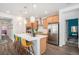Bright kitchen features a large island with seating and stainless steel appliances at 3522 N Buchanan Way, Aurora, CO 80019