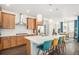 Stylish kitchen island with pendant lighting and views to the dining area at 3522 N Buchanan Way, Aurora, CO 80019