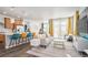 Bright open-concept living space with kitchen island, modern decor, and hardwood flooring at 3522 N Buchanan Way, Aurora, CO 80019