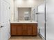 Bathroom with a double vanity, a large mirror, tiled flooring, and a glass-enclosed shower at 10771 N Montane Dr, Broomfield, CO 80021