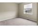 Bedroom featuring neutral paint, carpet flooring, and a window at 10771 N Montane Dr, Broomfield, CO 80021