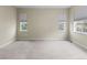Bright bedroom with carpeting, neutral walls, and multiple windows offering ample natural light at 10771 N Montane Dr, Broomfield, CO 80021