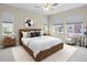 Comfortable bedroom with a cozy rug, wooden furniture, a ceiling fan, and natural light at 10771 N Montane Dr, Broomfield, CO 80021