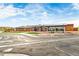 Wide view of the community clubhouse, landscaping, parking lot, and blue sky at 10771 N Montane Dr, Broomfield, CO 80021