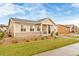 Charming ranch style home with tan siding, stone accents, landscaped yard, and covered porch at 10771 N Montane Dr, Broomfield, CO 80021