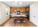 Spacious kitchen with stainless steel appliances, center island with seating, and wood floors at 10771 N Montane Dr, Broomfield, CO 80021
