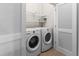 Laundry room featuring newer model washer and dryer with white cabinets at 10771 N Montane Dr, Broomfield, CO 80021