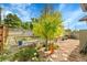 Landscaped backyard featuring patio, decorative accents, and a mature tree at 5175-5185 Simms Pl, Wheat Ridge, CO 80033