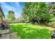 Large backyard with green lawn and mature trees at 5175-5185 Simms Pl, Wheat Ridge, CO 80033