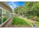 Backyard with lush lawn and large windows on the side of the home at 5175-5185 Simms Pl, Wheat Ridge, CO 80033