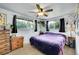Bedroom featuring a ceiling fan, natural light, and dresser at 5175-5185 Simms Pl, Wheat Ridge, CO 80033