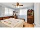 Comfortable bedroom with hardwood floors, featuring large windows and stylish furniture at 5175-5185 Simms Pl, Wheat Ridge, CO 80033