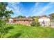 Spacious front yard featuring lush green grass and mature landscaping, creating a serene setting at 5175-5185 Simms Pl, Wheat Ridge, CO 80033