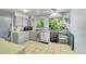 Bright kitchen with white cabinets, tiled floors, and natural light at 5175-5185 Simms Pl, Wheat Ridge, CO 80033