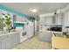 Kitchen features gray cabinets, tile flooring, and ample counter space at 5175-5185 Simms Pl, Wheat Ridge, CO 80033