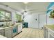 Bright kitchen featuring tile floors, white appliances, and natural light at 5175-5185 Simms Pl, Wheat Ridge, CO 80033