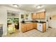Bright kitchen features wooden cabinets and a view of the adjacent living area at 5175-5185 Simms Pl, Wheat Ridge, CO 80033