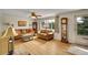 Bright living room with hardwood floors, featuring comfortable furnishings and an abundance of natural light at 5175-5185 Simms Pl, Wheat Ridge, CO 80033
