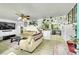 Bright living room with plants, ceiling fan, and open layout at 5175-5185 Simms Pl, Wheat Ridge, CO 80033