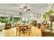 Open living room with hardwood floors, ceiling fan, and large windows at 5175-5185 Simms Pl, Wheat Ridge, CO 80033