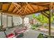 Outdoor patio with wooden pergola, decorative table, and landscaping at 5175-5185 Simms Pl, Wheat Ridge, CO 80033