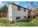 An eye-level view of the backyard with well-maintained green grass and a white brick house at 5300 Tabor St, Arvada, CO 80002