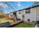 A beautiful backyard featuring well-kept lawn, a wooden deck with stairs and a clean white brick house at 5300 Tabor St, Arvada, CO 80002