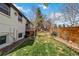 Large backyard featuring a wooden fence and green lawn at 5300 Tabor St, Arvada, CO 80002