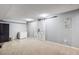 Finished basement featuring sliding barn doors and neutral carpet at 5300 Tabor St, Arvada, CO 80002