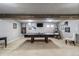 Recreational basement featuring a ping pong table, a TV, and a lounging chair at 5300 Tabor St, Arvada, CO 80002