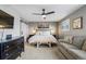 Relaxing primary bedroom features a ceiling fan, artwork, and comfortable furnishings at 5300 Tabor St, Arvada, CO 80002