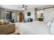 Open primary bedroom with a large bed, deck access, and ensuite bathroom at 5300 Tabor St, Arvada, CO 80002