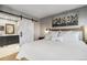 Serene primary bedroom with ensuite bathroom access, soft lighting, and neutral decor at 5300 Tabor St, Arvada, CO 80002