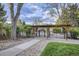 Inviting community entrance with a charming pergola, leading to well-maintained amenities at 5300 Tabor St, Arvada, CO 80002