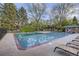 A refreshing community pool surrounded by lush greenery, perfect for relaxation and recreation at 5300 Tabor St, Arvada, CO 80002