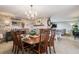 Open-concept dining room featuring a brick wall, fireplace, and seamlessly flows into the living area at 5300 Tabor St, Arvada, CO 80002
