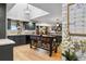 Kitchen featuring dark cabinets, a central island, hardwood floors, and a large calendar at 5300 Tabor St, Arvada, CO 80002