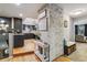 An open concept kitchen/living room with hardwood floors, brick wall and plenty of room for entertaining at 5300 Tabor St, Arvada, CO 80002